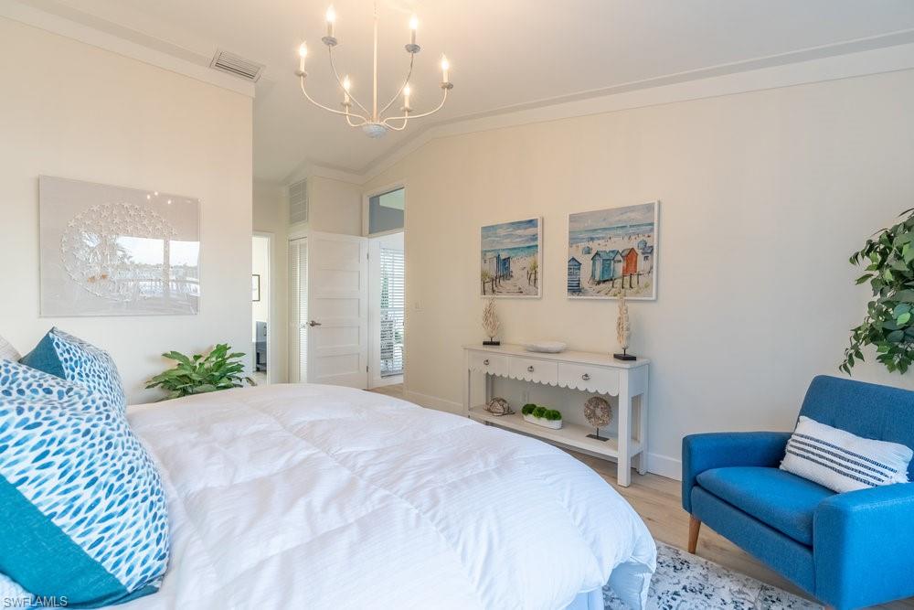 6831 Mill Pond Circle Naples, FL 34109 - Photo 11 of 45 a spacious bedroom with a bed and furniture