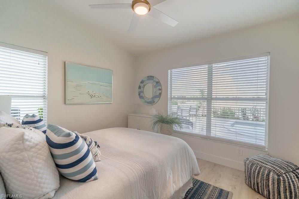 6831 Mill Pond Circle Naples, FL 34109 - Photo 15 of 45 a bedroom with a bed and a window