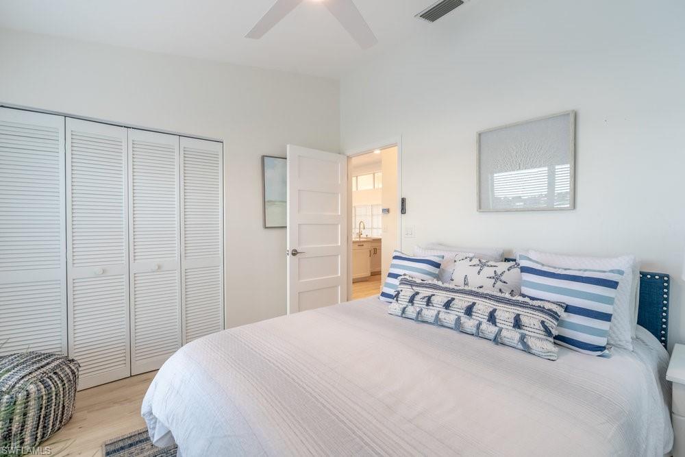 6831 Mill Pond Circle Naples, FL 34109 - Photo 16 of 45 a bedroom with a bed and a table