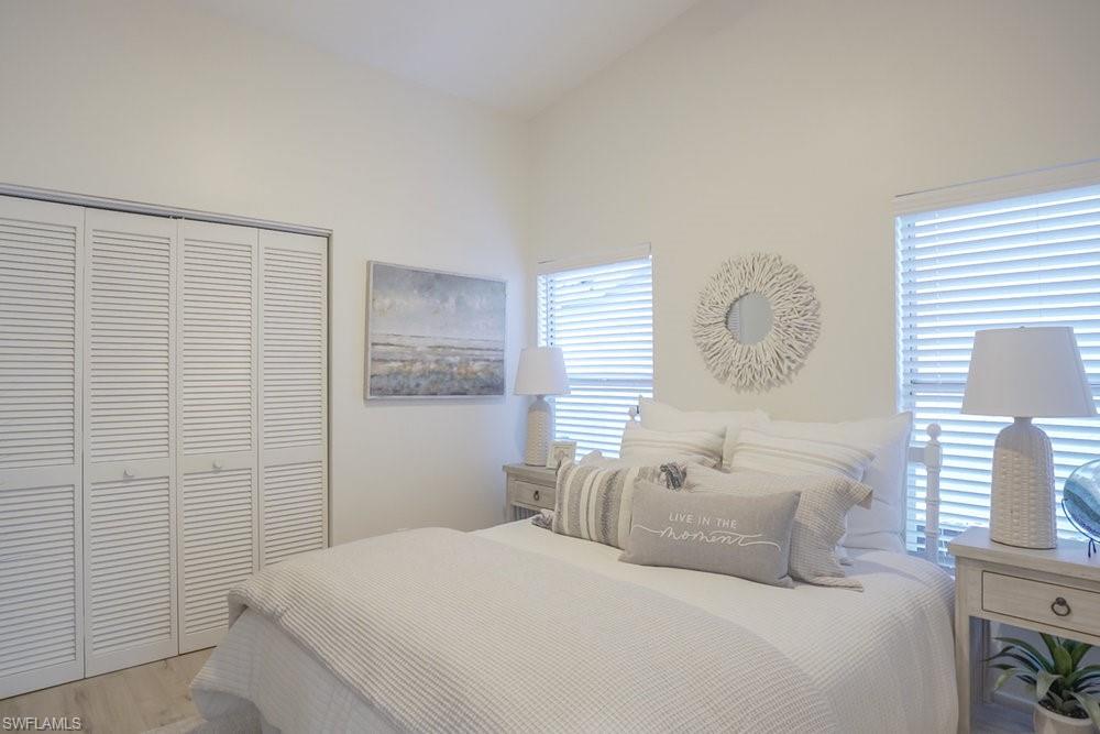 6831 Mill Pond Circle Naples, FL 34109 - Photo 18 of 45 a bedroom with a bed and a window