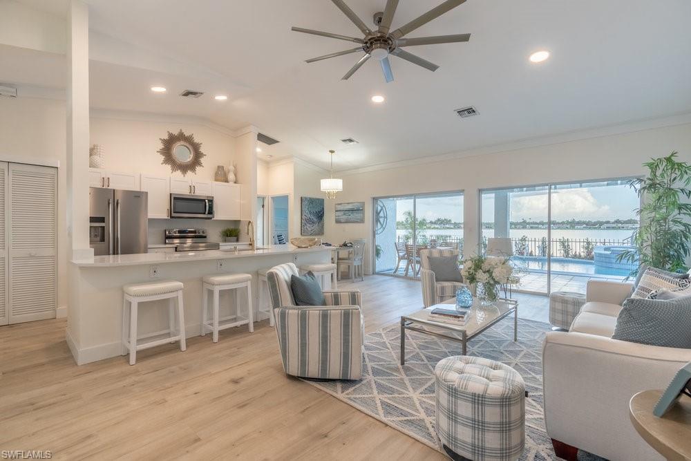 6831 Mill Pond Circle Naples, FL 34109 - Photo 45 of 45 a living room with furniture and a large window