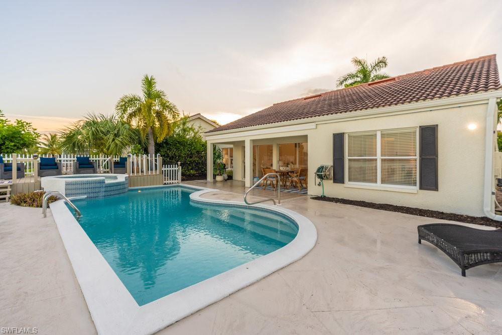 6831 Mill Pond Circle Naples, FL 34109 - Photo 29 of 45 a view of a house with swimming pool and sitting area