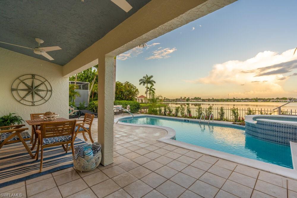 6831 Mill Pond Circle Naples, FL 34109 - Photo 30 of 45 a view of a swimming pool and lounge chair