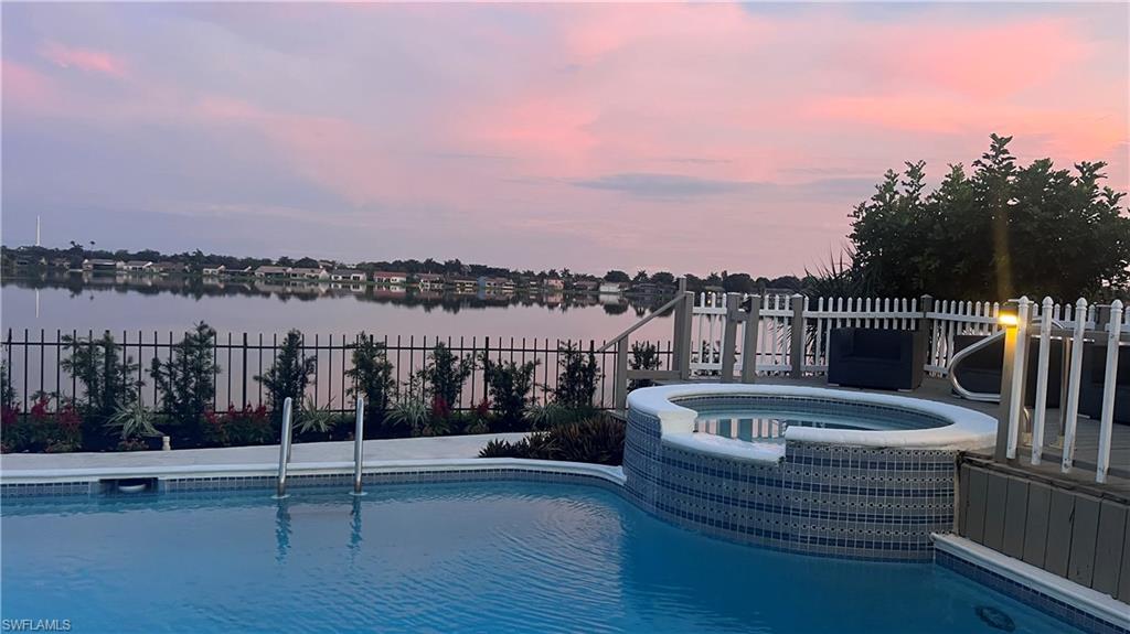 6831 Mill Pond Circle Naples, FL 34109 - Photo 31 of 45 a roof deck with couches and city view