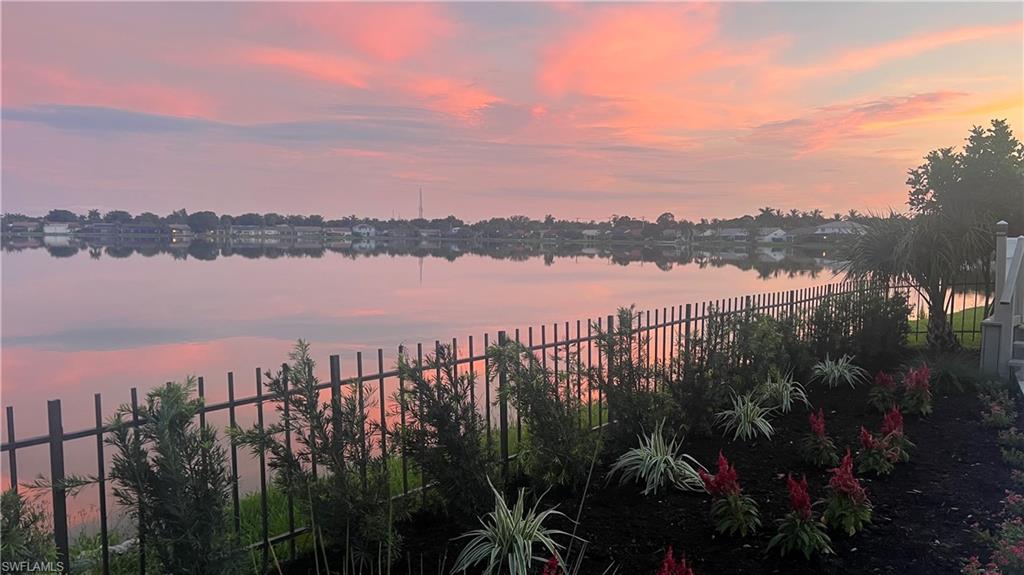 6831 Mill Pond Circle Naples, FL 34109 - Photo 32 of 45 a view of a lake and a mountain view