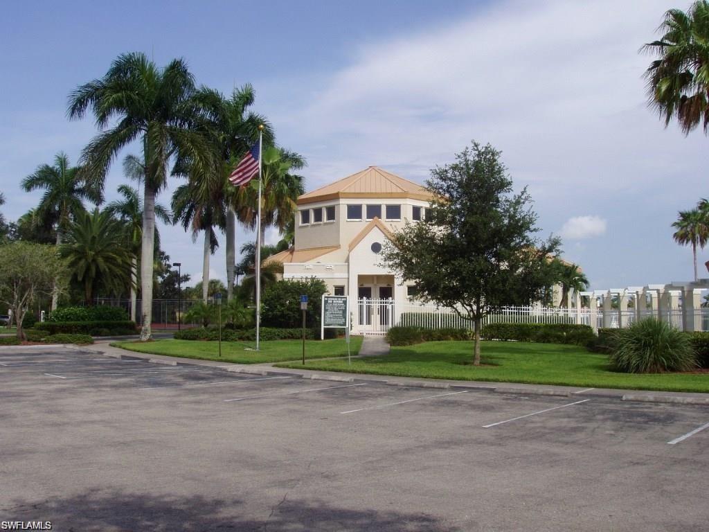 6831 Mill Pond Circle Naples, FL 34109 - Photo 40 of 45 a view of a white house with a big yard and palm trees