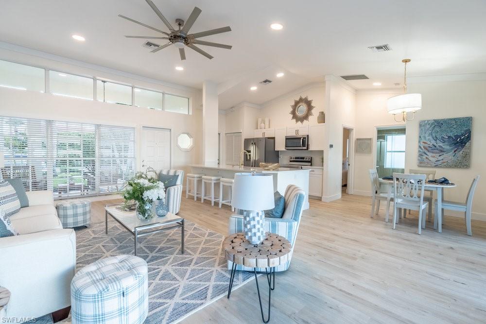 6831 Mill Pond Circle Naples, FL 34109 - Photo 4 of 45 a dining room with kitchen island stainless steel appliances furniture dining table and a large window