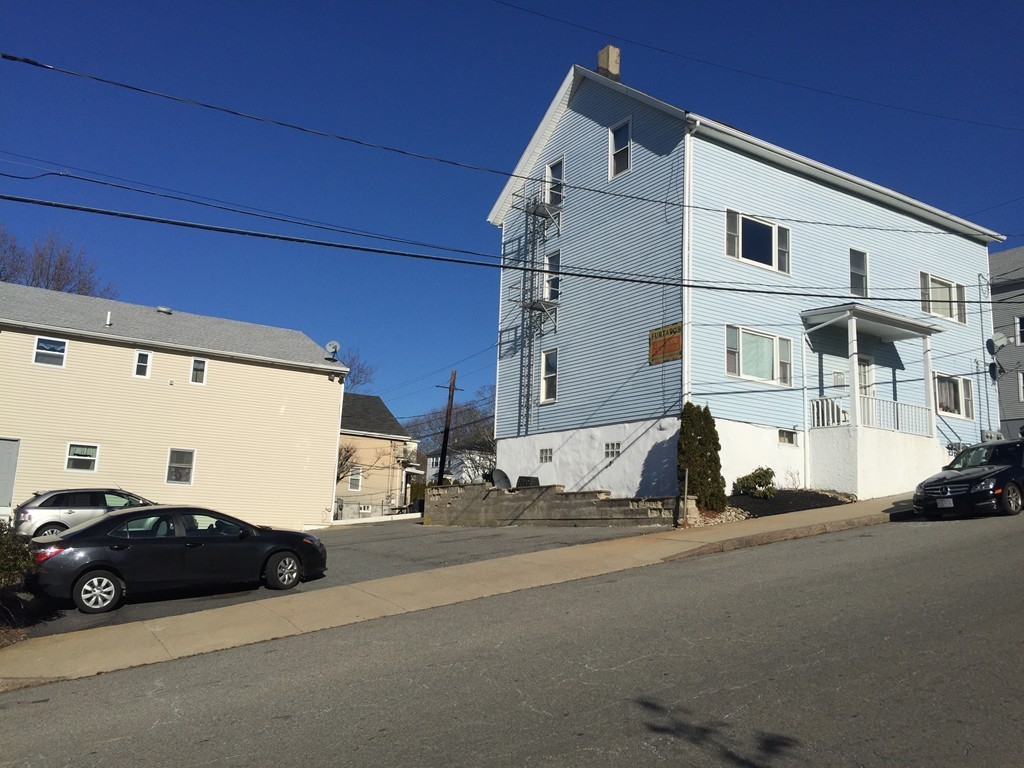 128 Stewart Street Fall River, MA 02720 - Photo 2 of 14 a view of a street with cars