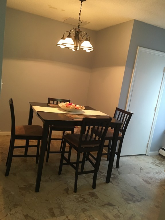 128 Stewart Street Fall River, MA 02720 - Photo 7 of 14 a view of a dining room with furniture and wooden floor