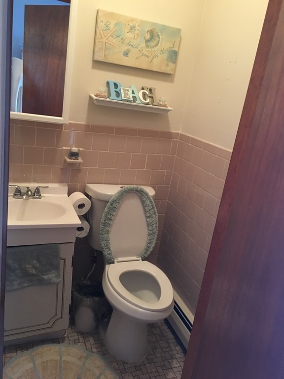 128 Stewart Street Fall River, MA 02720 - Photo 8 of 14 a white toilet sitting next to a sink