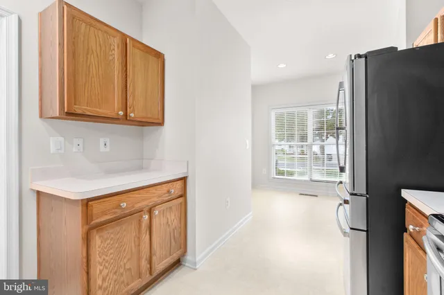 a kitchen with stainless steel appliances granite countertop a refrigerator a stove top oven a sink and dishwasher