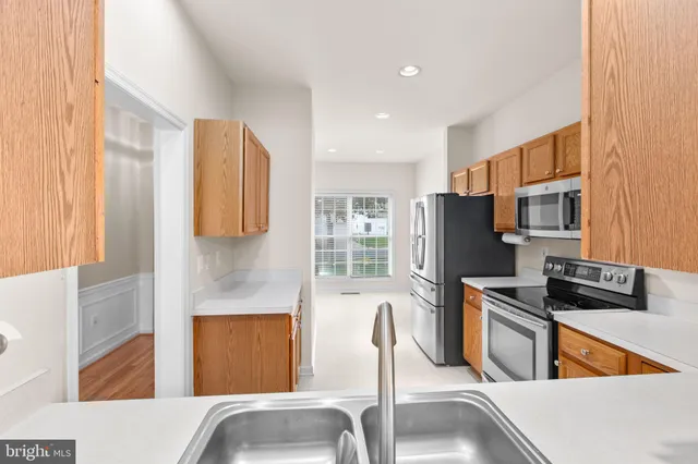 a kitchen with stainless steel appliances granite countertop a refrigerator sink and microwave