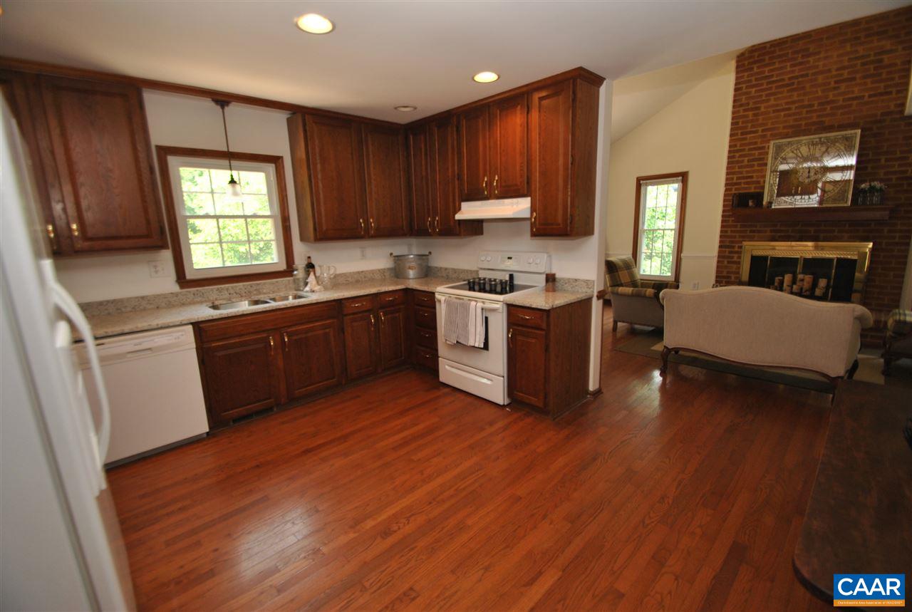 1606 Old Brook Road Charlottesville, VA 22901 - Photo 11 of 32 a kitchen with wooden floors and wooden cabinets