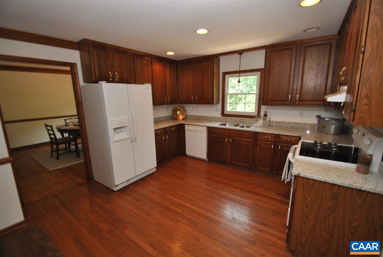 1606 Old Brook Road Charlottesville, VA 22901 - Photo 12 of 32 a kitchen with wooden floors and white stainless steel appliances