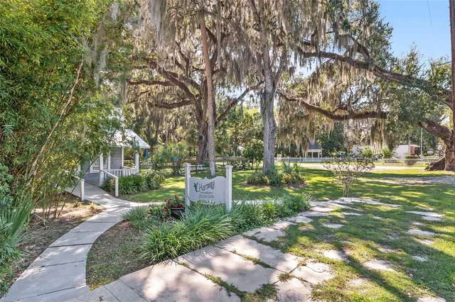 a view of a yard with a house in the background