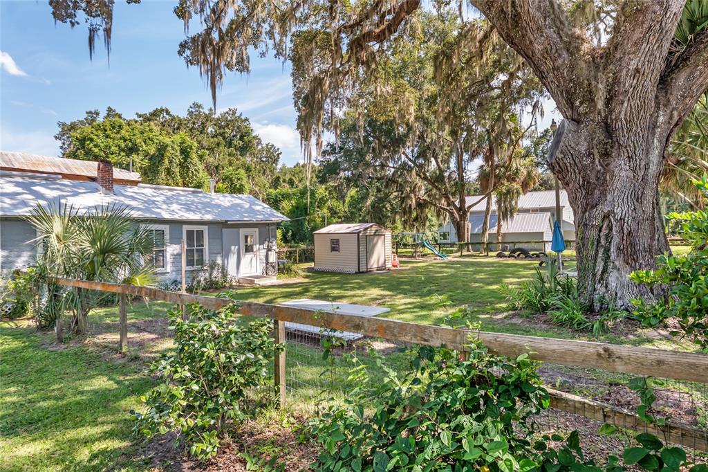 5610 Avenue G McIntosh, FL 32664 - Photo 14 of 64 a front view of a house with garden