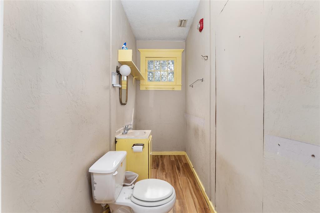 5610 Avenue G McIntosh, FL 32664 - Photo 29 of 64 a white toilet sitting next to a shower curtain