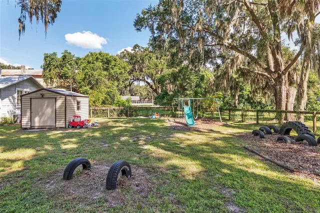 a view of a house with a yard and sitting area