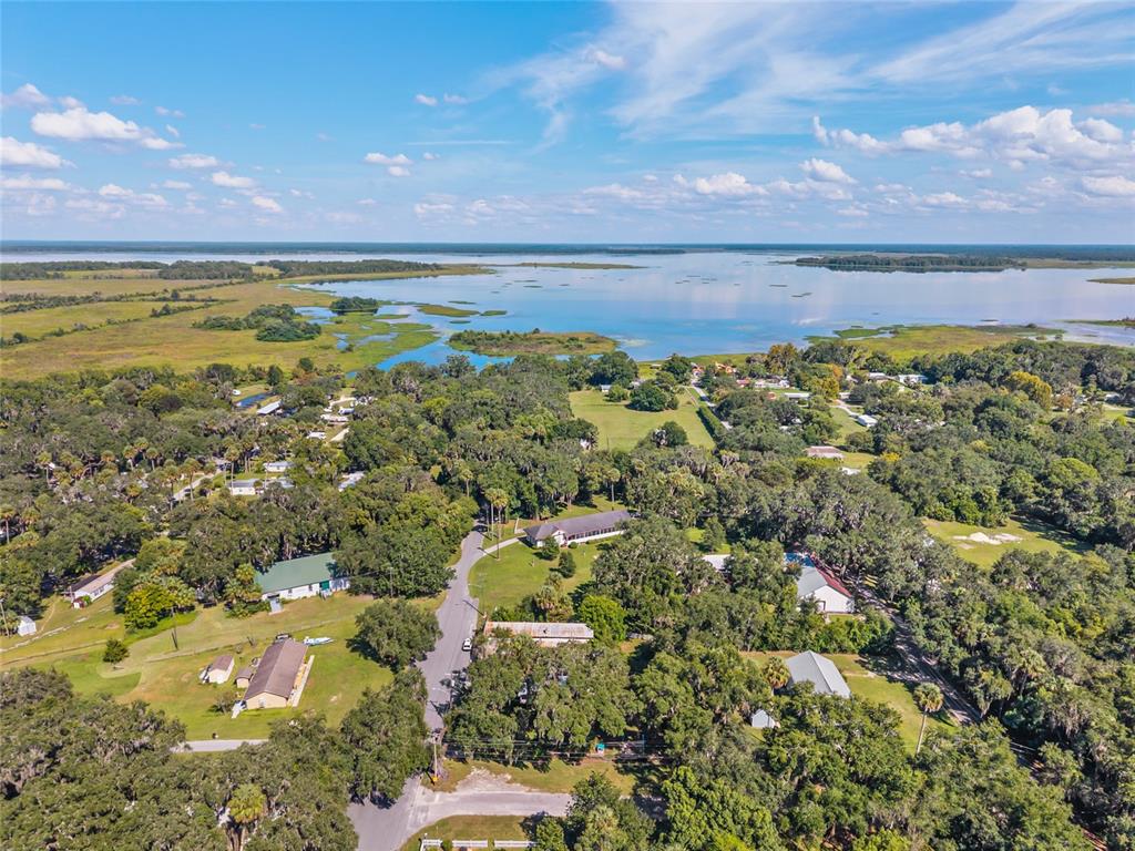 5610 Avenue G McIntosh, FL 32664 - Photo 64 of 64 a view of a lake with a building in the background