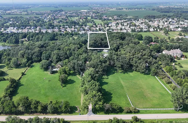 an aerial view of a house with a yard