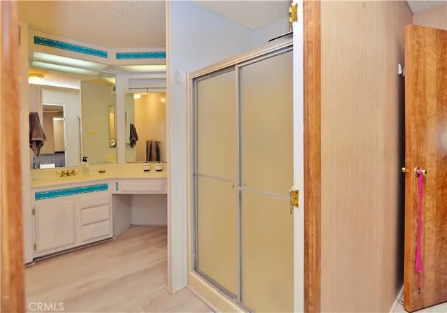 a bathroom with a double vanity sink a mirror and a bathtub