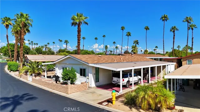 an aerial view of a house with garden space and potted plants