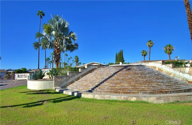 a view of a backyard with plants and a patio