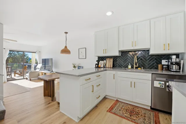 a kitchen with a white cabinets and window