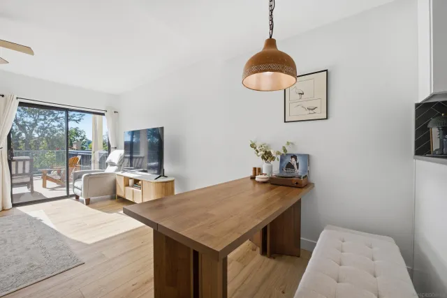 a living room with furniture a flat screen tv and a table
