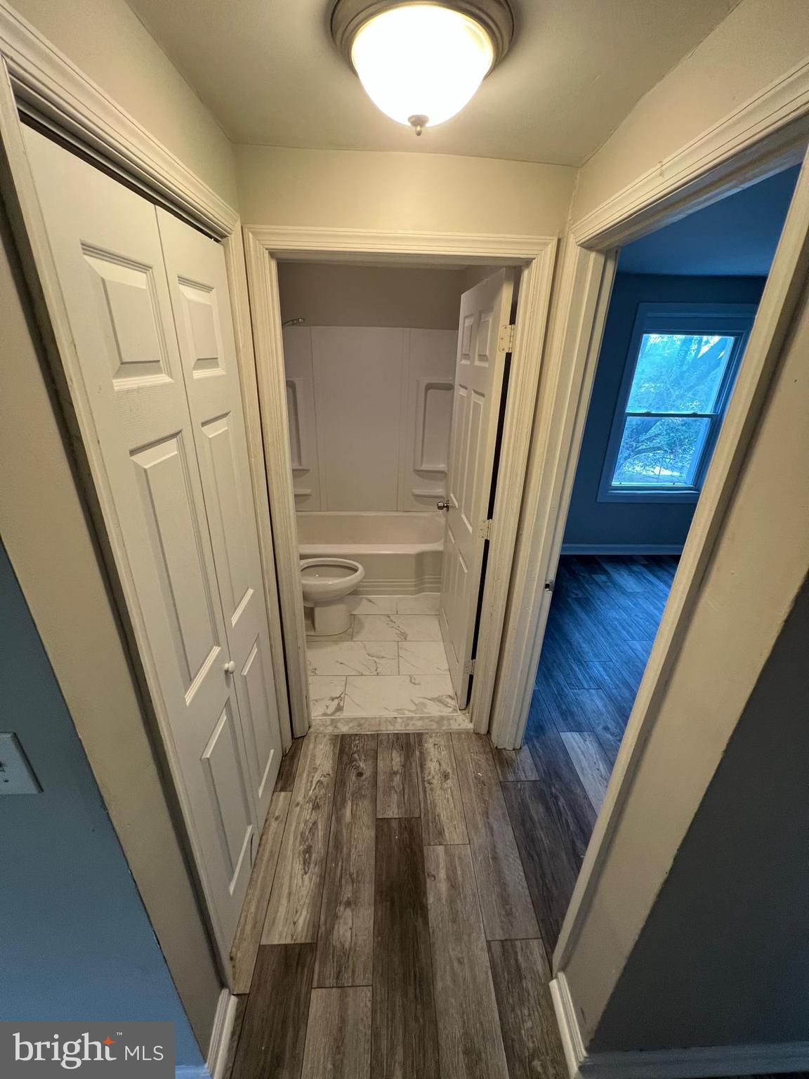1025 Elton Avenue Baltimore, MD 21224 - Photo 3 of 11 a view of a hallway with wooden floor and staircase