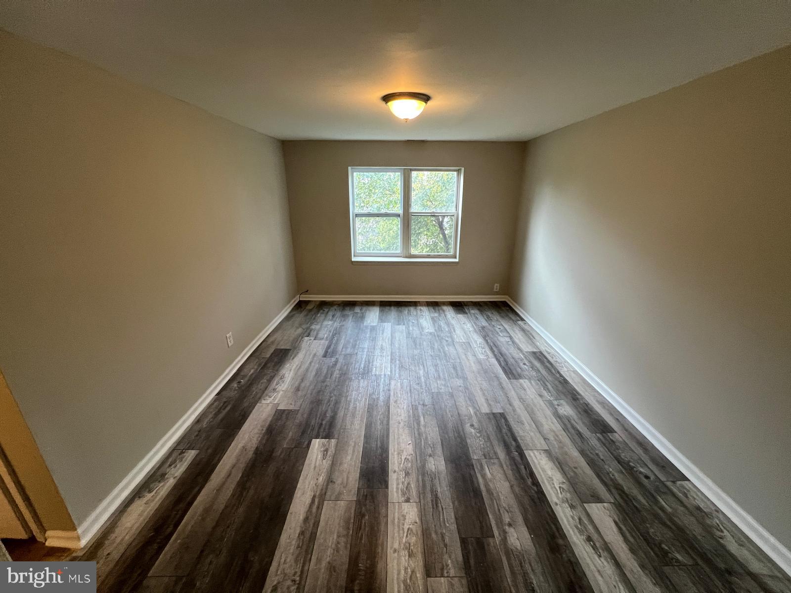 1025 Elton Avenue Baltimore, MD 21224 - Photo 8 of 11 wooden floor in an empty room with window