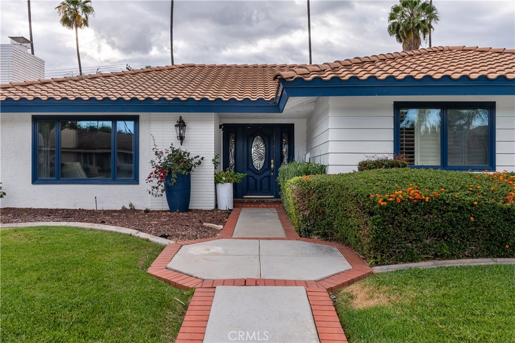 4967 Chapala Drive Riverside, CA 92507 - Photo 6 of 34 a front view of a house with a yard and potted plants