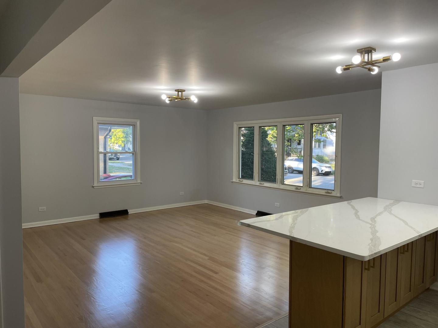 18452 Oakwood Avenue Lansing, IL 60438 - Photo 13 of 21 an empty room with wooden floor cabinet and windows