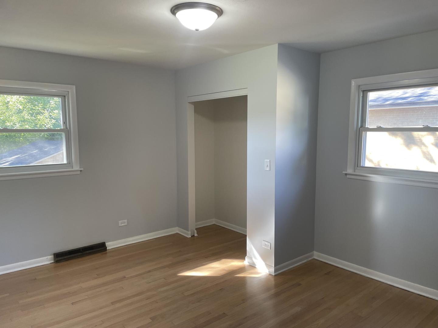 18452 Oakwood Avenue Lansing, IL 60438 - Photo 15 of 21 an empty room with wooden floor and windows