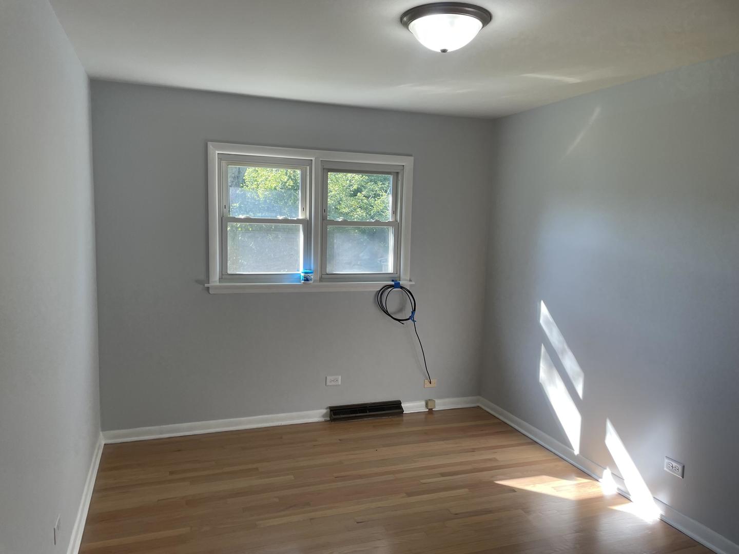 18452 Oakwood Avenue Lansing, IL 60438 - Photo 16 of 21 an empty room with wooden floor and windows