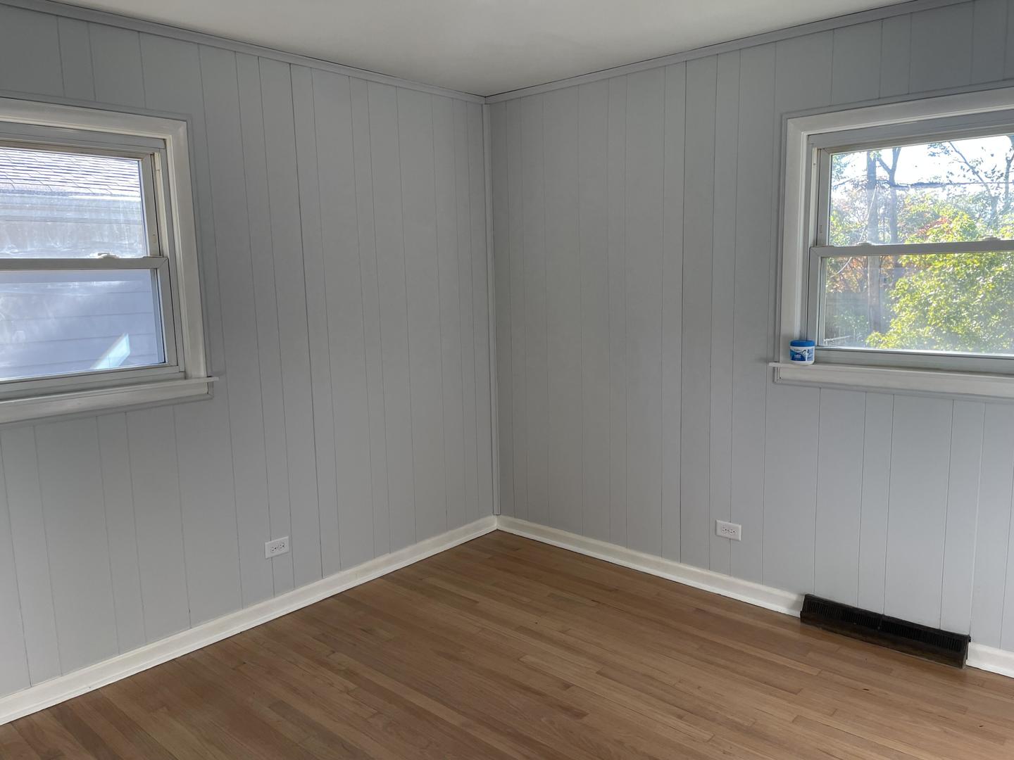 18452 Oakwood Avenue Lansing, IL 60438 - Photo 17 of 21 an empty room with wooden floor and windows