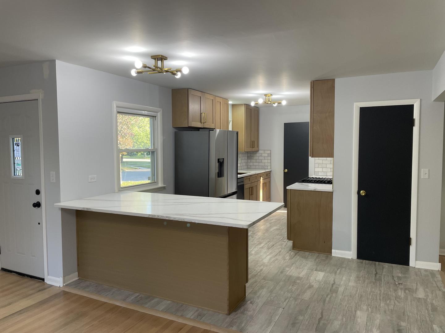 18452 Oakwood Avenue Lansing, IL 60438 - Photo 2 of 21 a view of a kitchen with a refrigerator a sink and a refrigerator