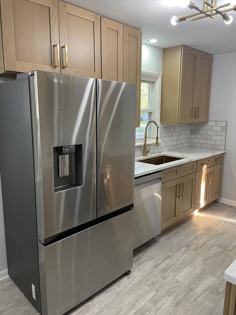 18452 Oakwood Avenue Lansing, IL 60438 - Photo 4 of 21 a kitchen with stainless steel appliances granite countertop a refrigerator a sink a stove and a refrigerator with wooden floor