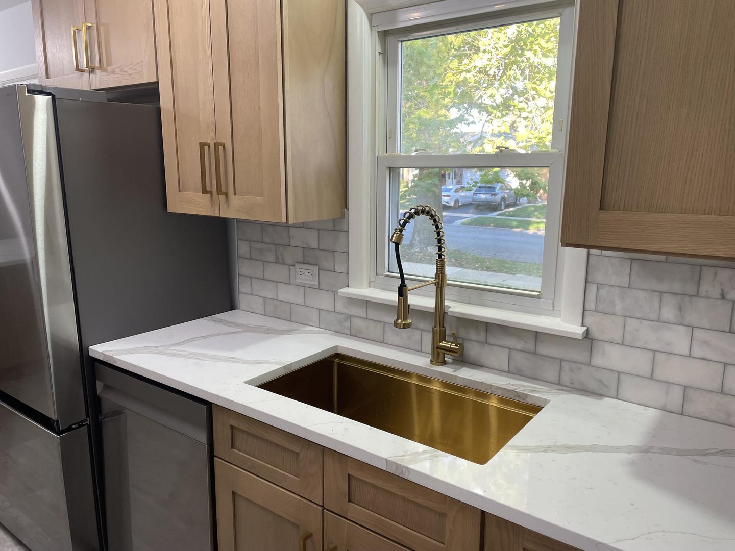 18452 Oakwood Avenue Lansing, IL 60438 - Photo 6 of 21 a kitchen with granite countertop a sink a refrigerator and a window