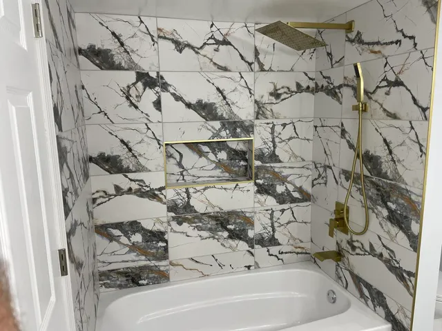 a bathroom with a bathtub and shower