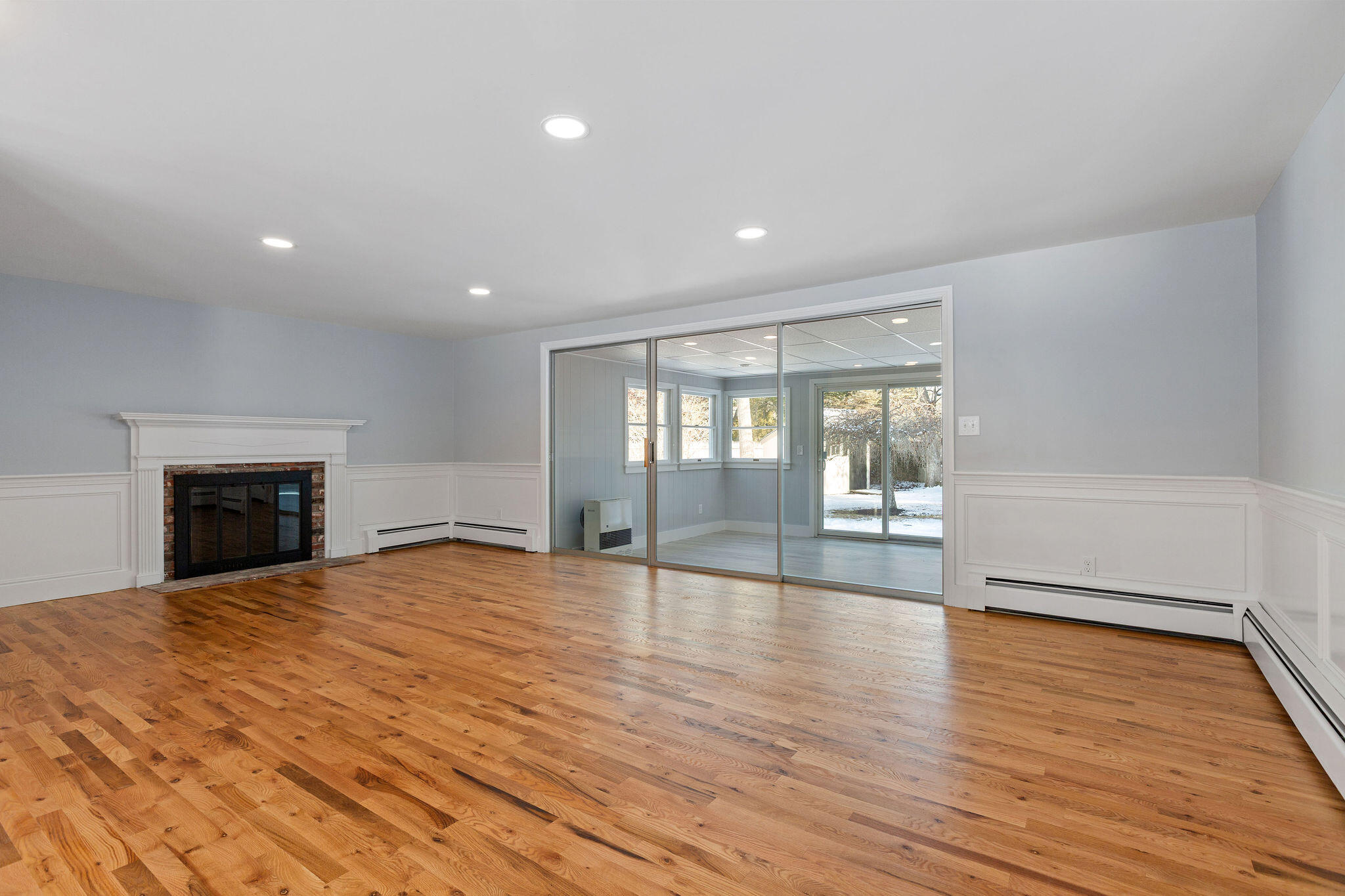 200 Lumbert Mill Road Centerville, MA 02632 - Photo 16 of 63 a view of empty room with wooden floor and fireplace