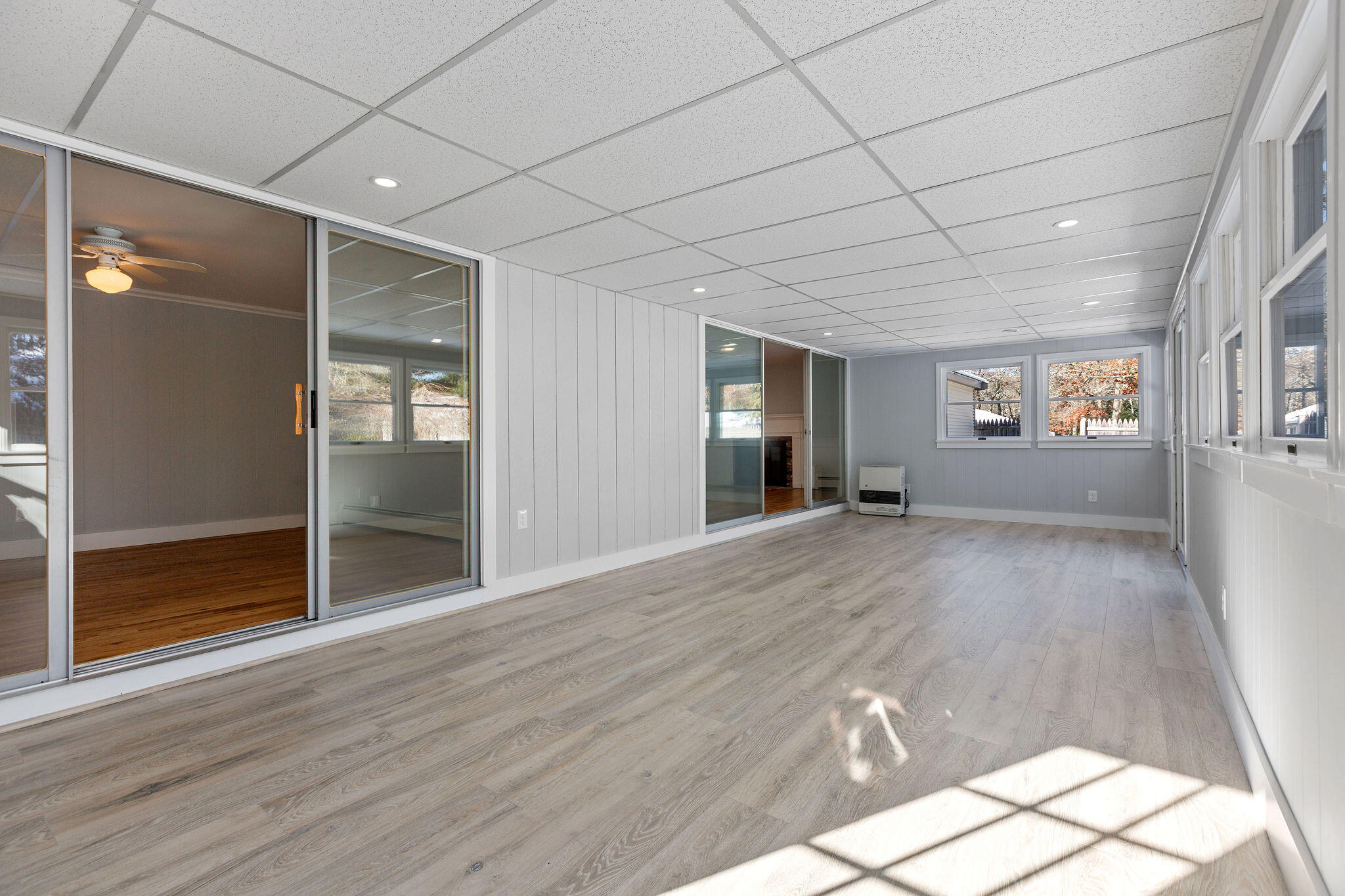 200 Lumbert Mill Road Centerville, MA 02632 - Photo 26 of 63 an empty room with wooden floor and windows