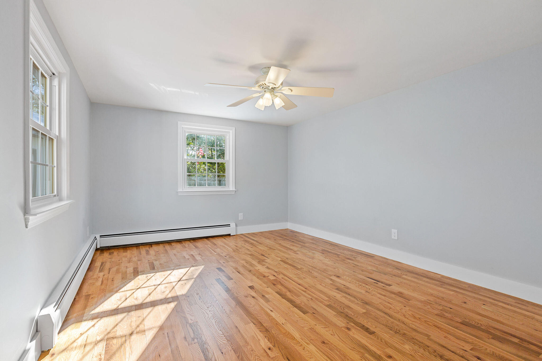 200 Lumbert Mill Road Centerville, MA 02632 - Photo 28 of 63 wooden floor in an empty room with a window