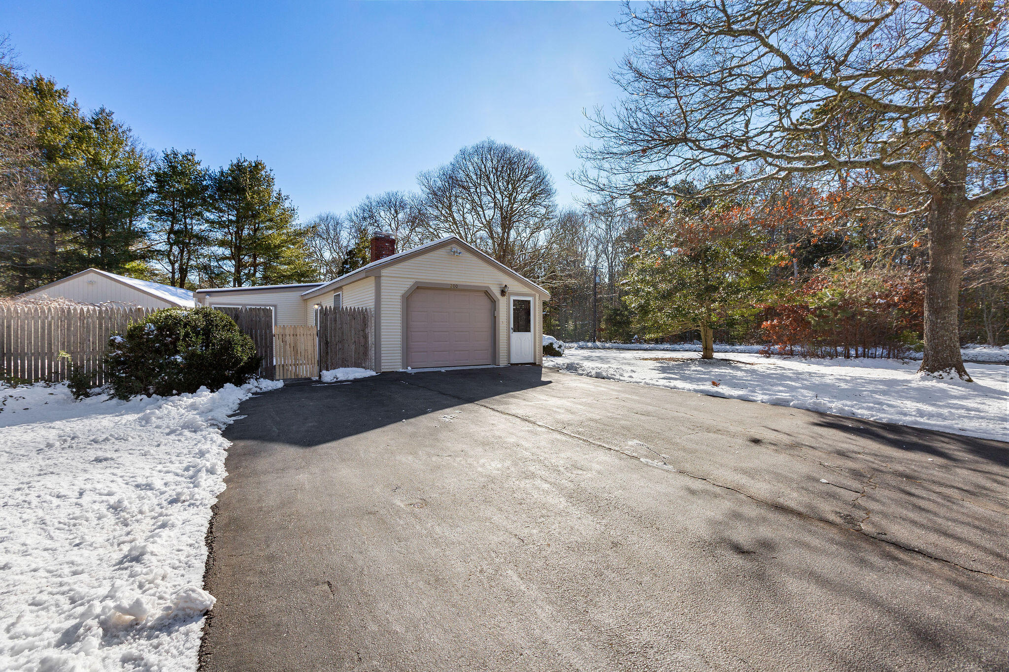 200 Lumbert Mill Road Centerville, MA 02632 - Photo 55 of 63 a view of a house with a yard covered in snow