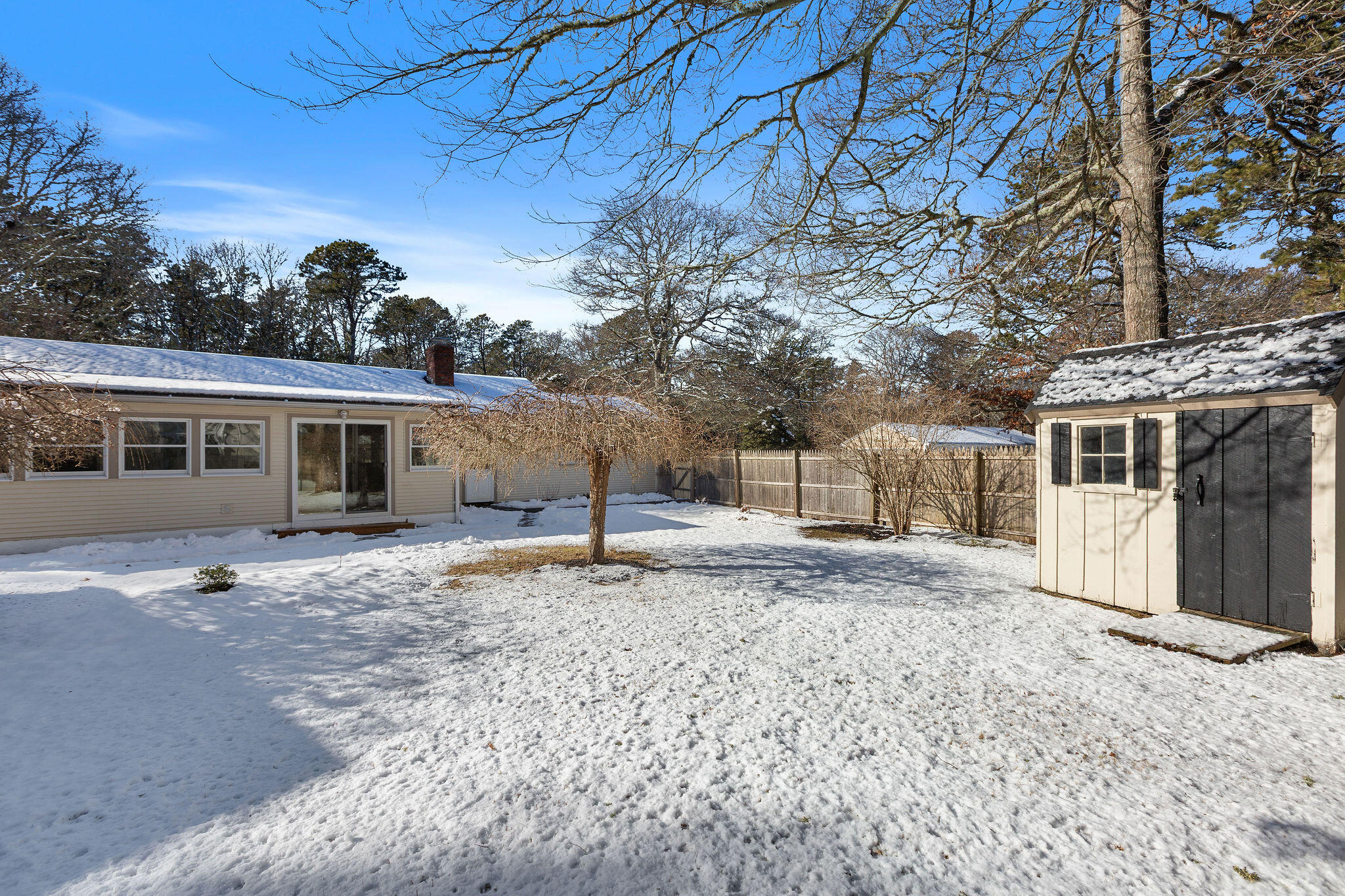 200 Lumbert Mill Road Centerville, MA 02632 - Photo 57 of 63 a front view of a house with a yard covered in snow