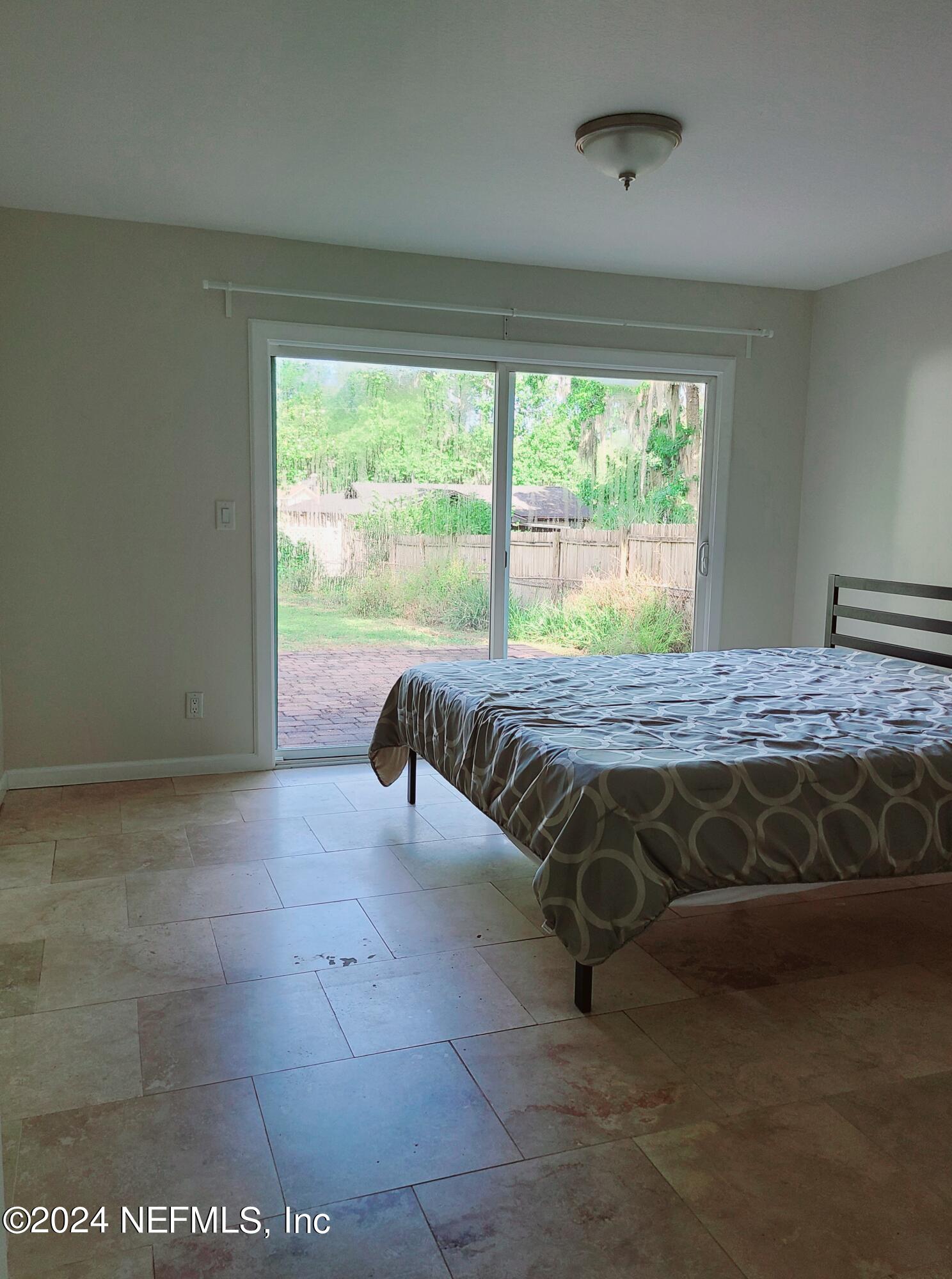 4620 Morris Road Jacksonville, FL 32225 - Photo 12 of 39 a bed sitting in a bedroom next to a window
