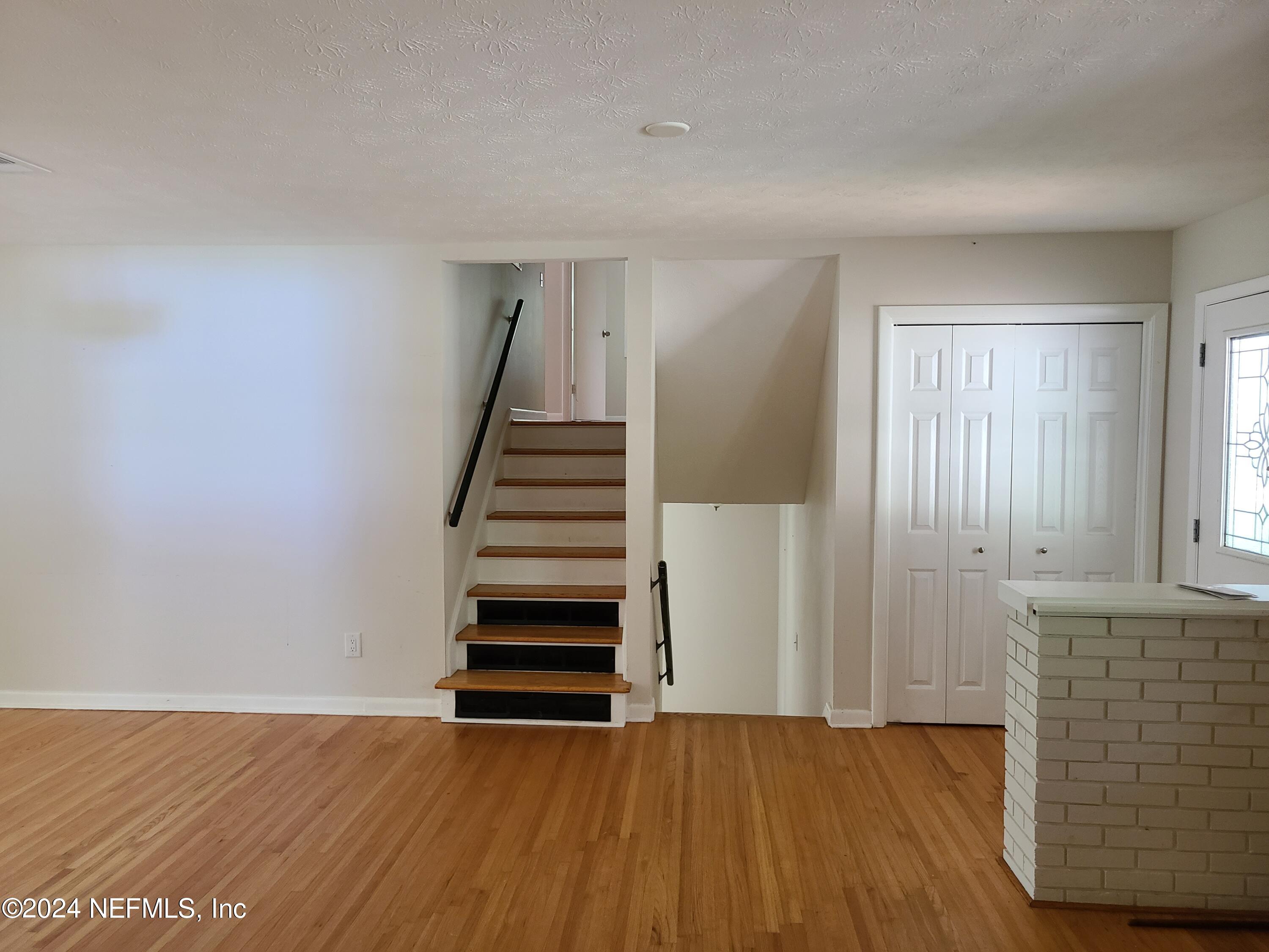 4620 Morris Road Jacksonville, FL 32225 - Photo 3 of 39 a view of an empty room with wooden floor and stairs
