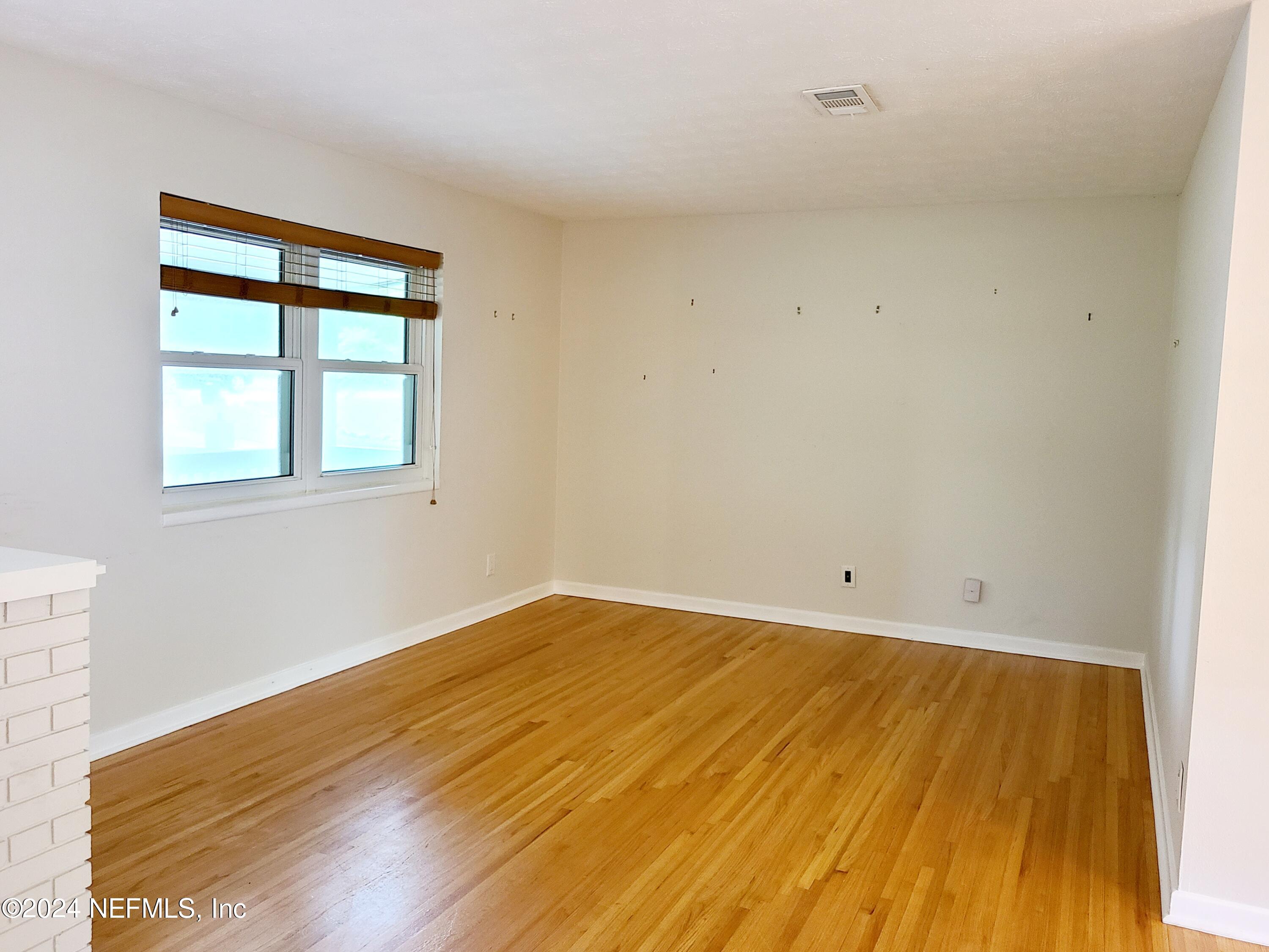 4620 Morris Road Jacksonville, FL 32225 - Photo 4 of 39 a view of empty room with wooden floor and fan
