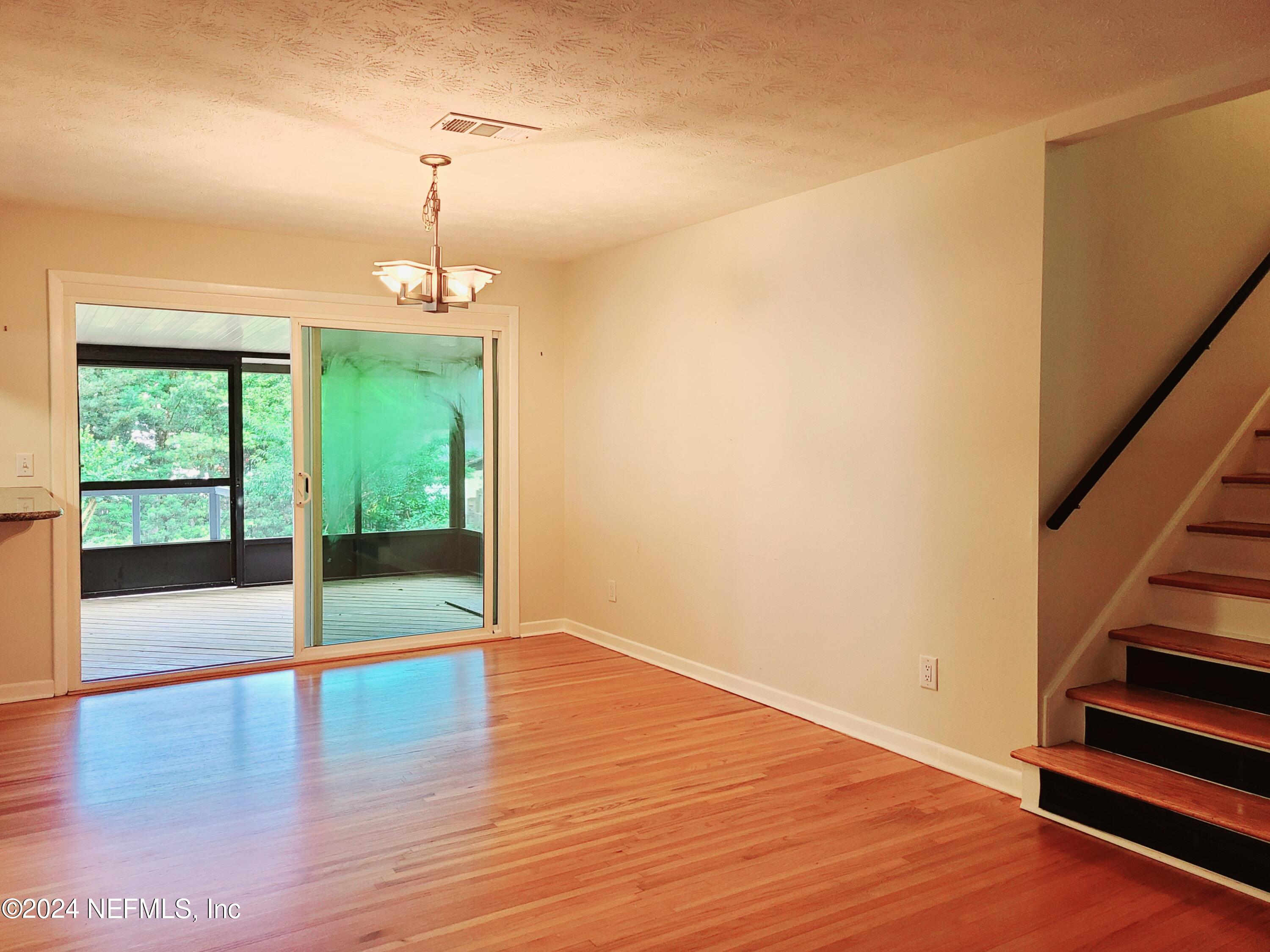 4620 Morris Road Jacksonville, FL 32225 - Photo 5 of 39 a view of an empty room with wooden floor and fan