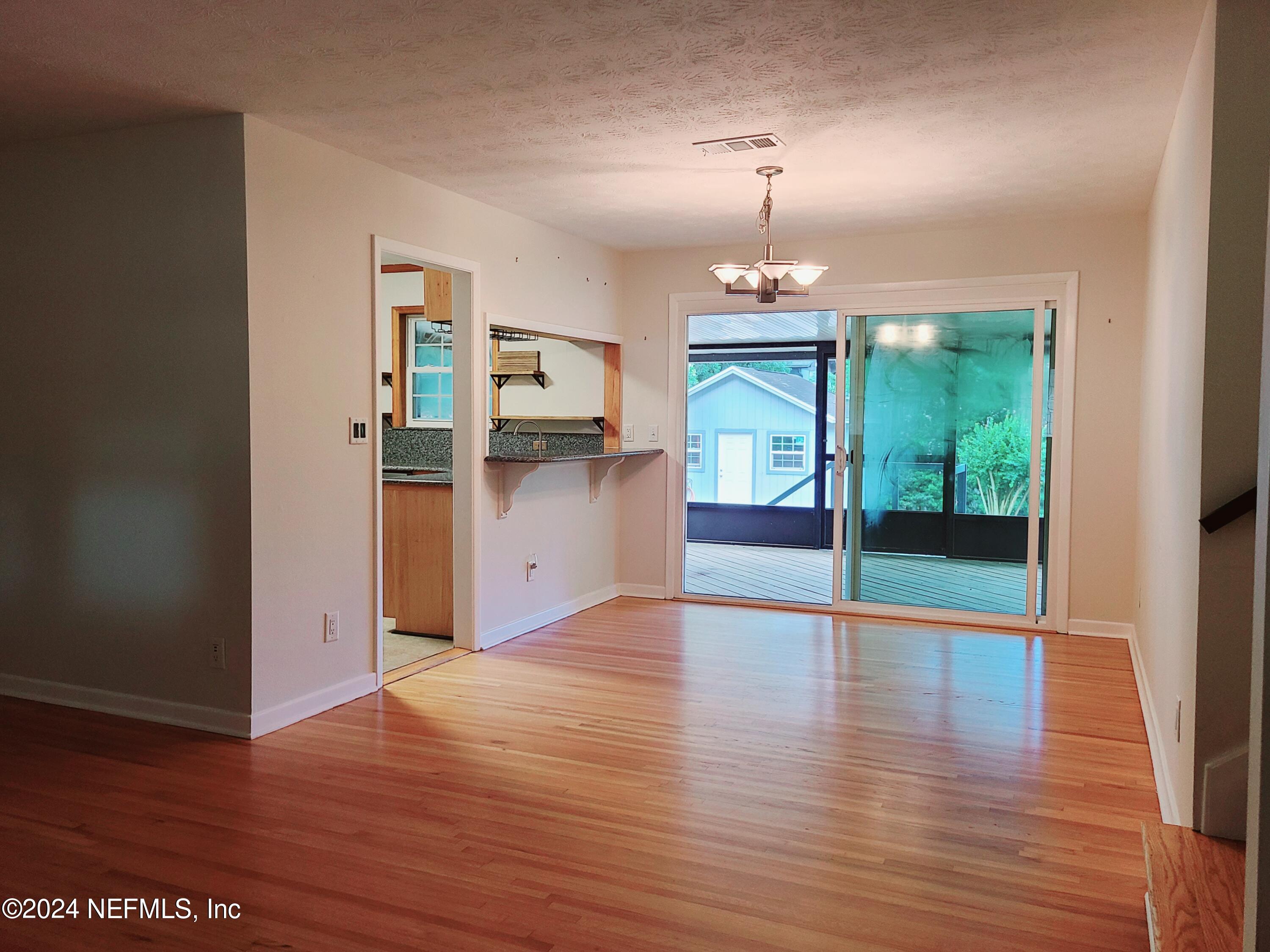 4620 Morris Road Jacksonville, FL 32225 - Photo 6 of 39 a view of a room with wooden floor kitchen view and a window